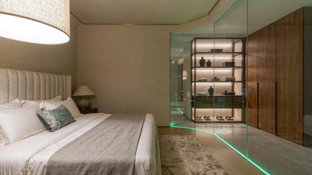 Luxury master bedroom with upholstered bed and walk-in closet